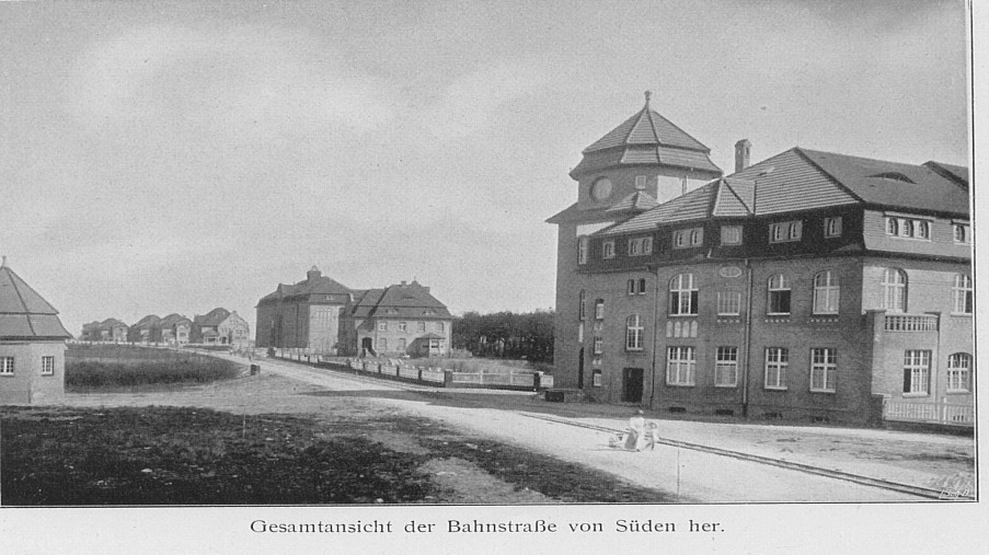 Schwarz-Weiß-Foto: Straße mit Häusern auf der rechten Seite