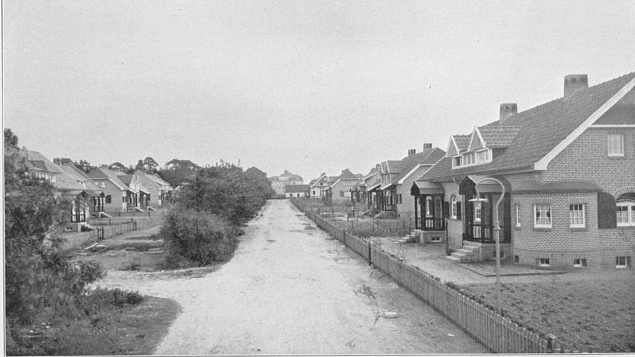 Schwarz-Weiß-Foto: eine Straße mit mehreren Häusern auf der linken und rechte Seite